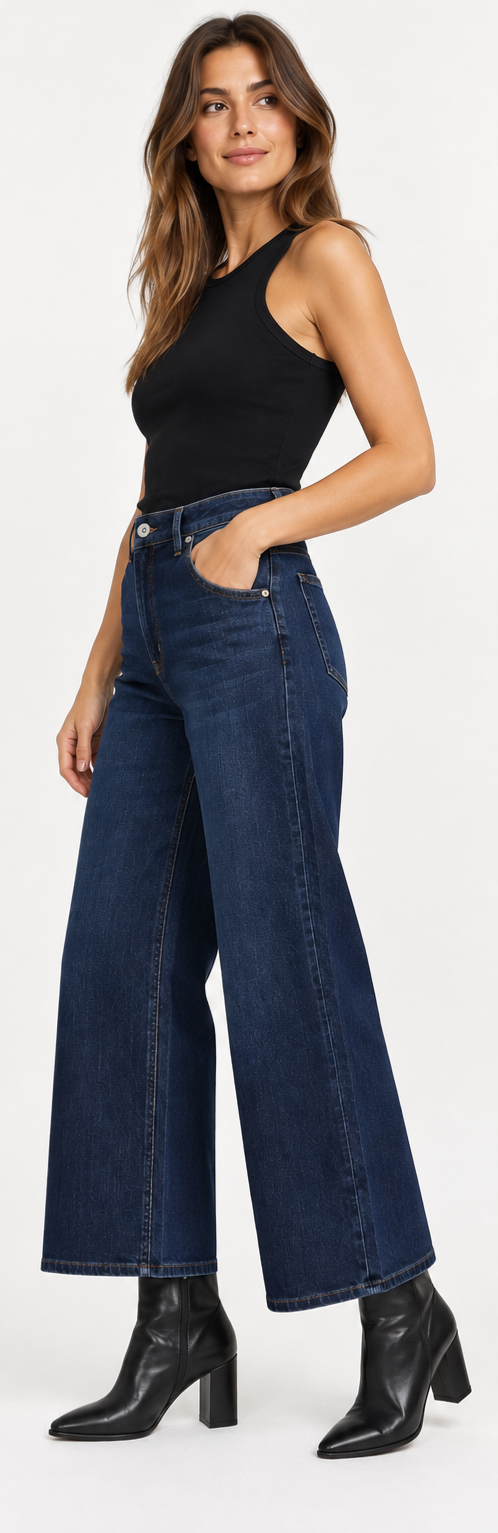 Modella indossa jeans a gamba larga blu scuro Teresa C. Casual Chic Lab con vita alta e stivaletti neri